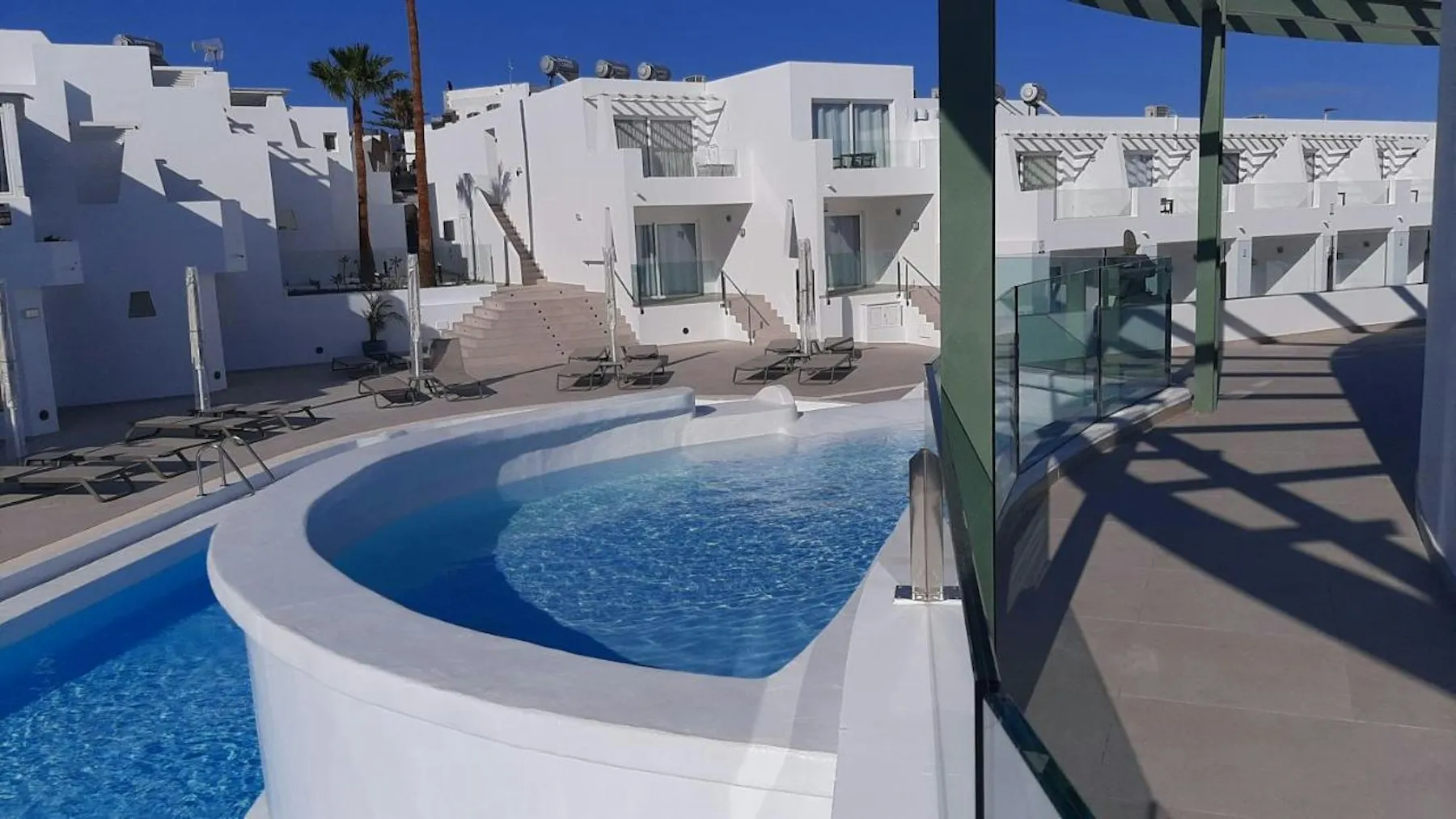 The shared pool at Tinasoria, with the white apartment blocks rising behind it.